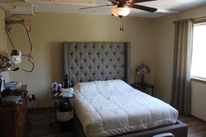 Bedroom with ceiling life in accessibile patio home for sale. 